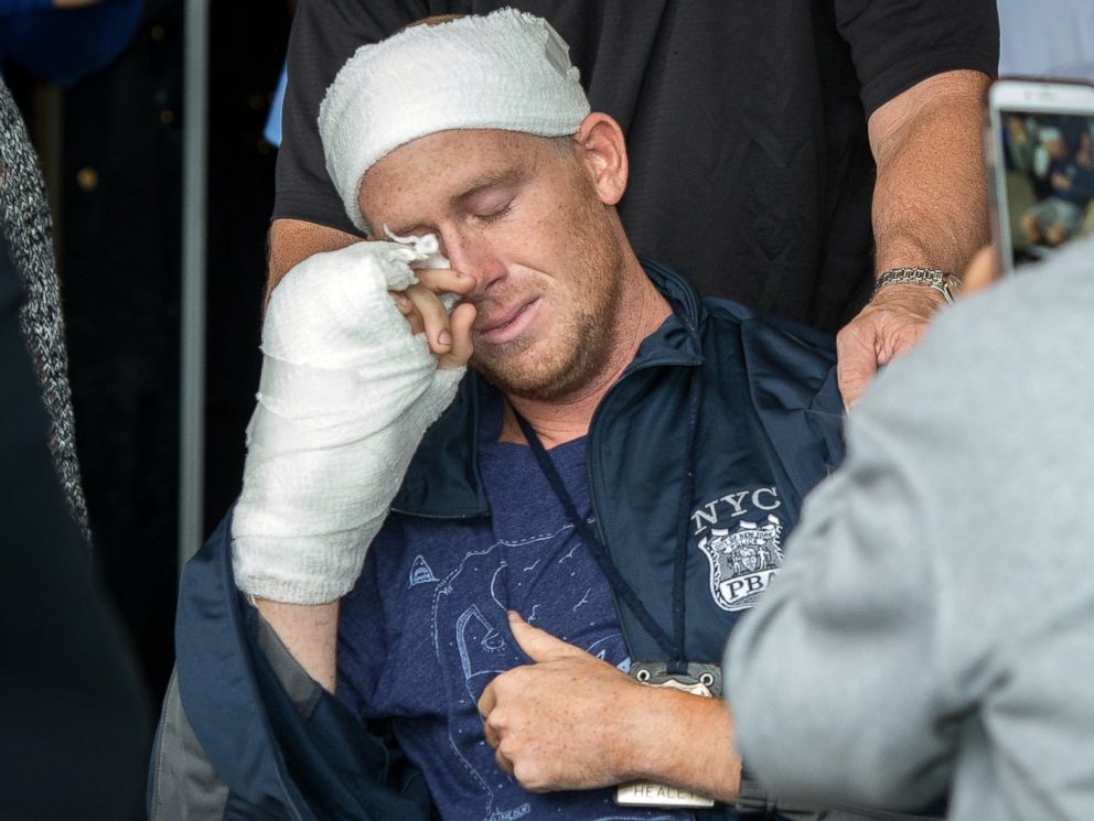PHOTO: NYPD Police Officer Kenneth Healey, 25, who was attack with a hatchet by Zale Thompson, wipes his tears as he was released from Jamaica Hospital Medical Center located at 8900 Van Wyck Expressway in Queens, Oct. 29, 2014.