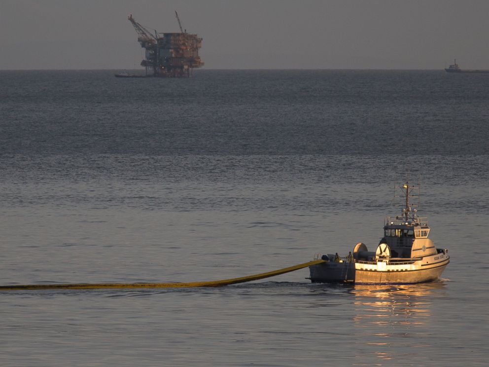 PHOTO: A boat with the nonprofit collective Clean Seas deploys a boom, with an oil platform seen in the distance, to try to contain an oil spill on May 19, 2015 north of Goleta, California.