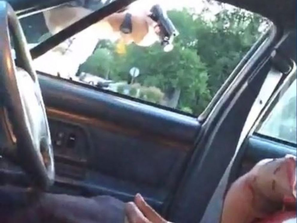PHOTO: Cell phone footage seen here shows the victim bleeding heavily in the passenger seat of a vehicle. The officer can be seen pointing a gun through the window in Falcon Heights, Minnesota, July, 6, 2016.