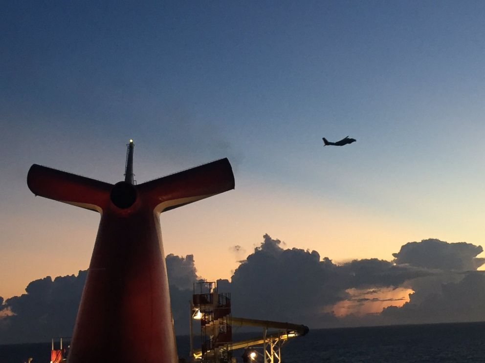 PHOTO: A helicopter is seen searching for a cruise ship passenger that fell overboard.