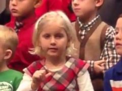 PHOTO: Claire Koch, 5, sings along with her classmates at her school’s holiday concert.