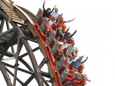 PHOTO: Riders cheer as they experience a vertical drop from the top of Goliath, June 18, 2014.