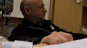 Mark Kelly holds the hand of Gabrielle Giffords