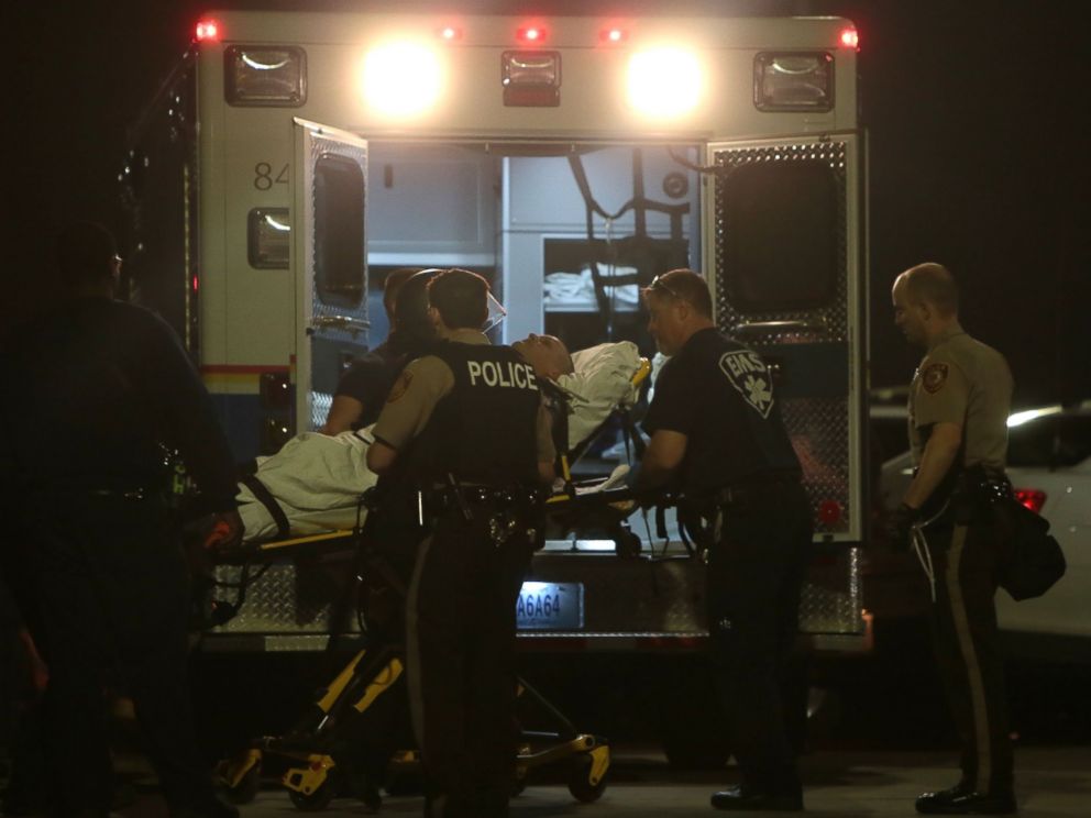 PHOTO: Paramedics load one of two police officer who were shot while standing guard in front of the Ferguson Police Station during a protest, March 12, 2015. 