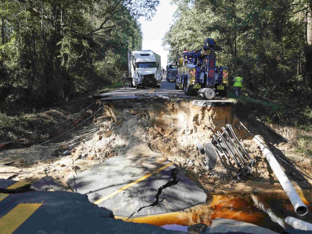 PHOTO: A semi truck that drove past a barricade is removed from a washed away road on Highway 117 as flood waters in the wake of Hurricane Matthew continue to rise in Goldsboro, North Carolina, Oct. 10, 2016. 