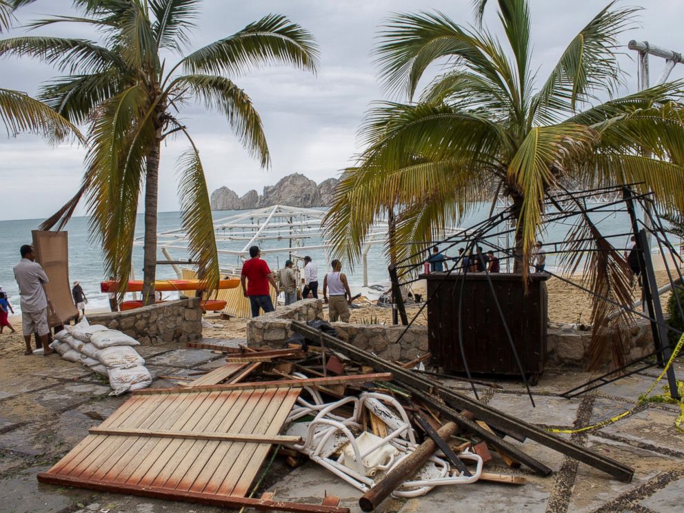 PHOTO: Residents stand next to debris of a restaurant in the aftermath of Hurricane Newton in Los Cabos, Mexico, Sept. 6, 2016.