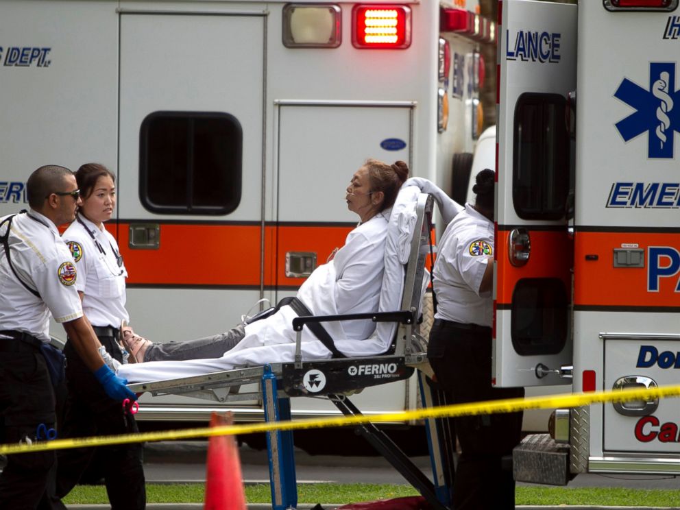 A woman, who exited the Marco Polo apartment complex, is placed in an ambulance as firefighters continue to battle the blaze at the high-rise, Friday, July 14, 2017, in Honolulu. (AP Photo/Marco Garcia)