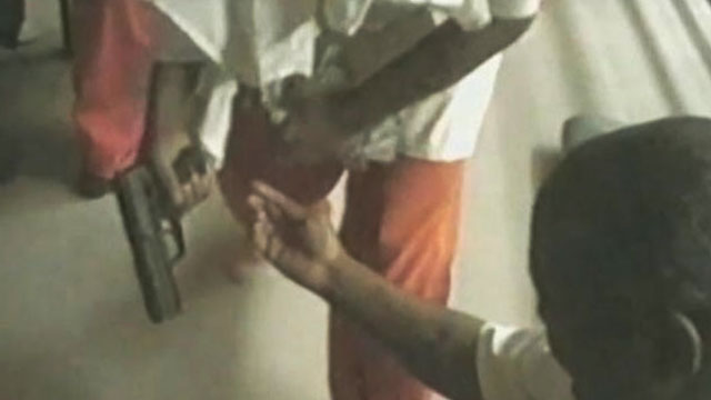 PHOTO: A video shown in court from Orleans Parish Prison shows prisoners allegedly with guns, and using drugs.