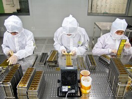 PHOTO: In designated "clean" areas, employees will have to don anti-static "bunny-suits." These three workers are assembling the camera module for Apple's iPad in a factory in China.
