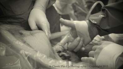 PHOTO: Baby Nevaeh Atkins holds Dr. Allan Sawyer's hand from inside her mother's womb.