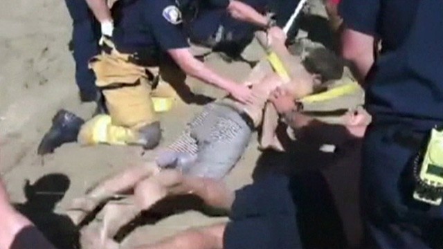 PHOTO:&nbsp;Matt Mina rescued on beach