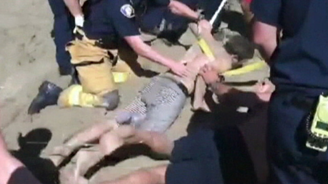 PHOTO: Matt Mina rescued on beach