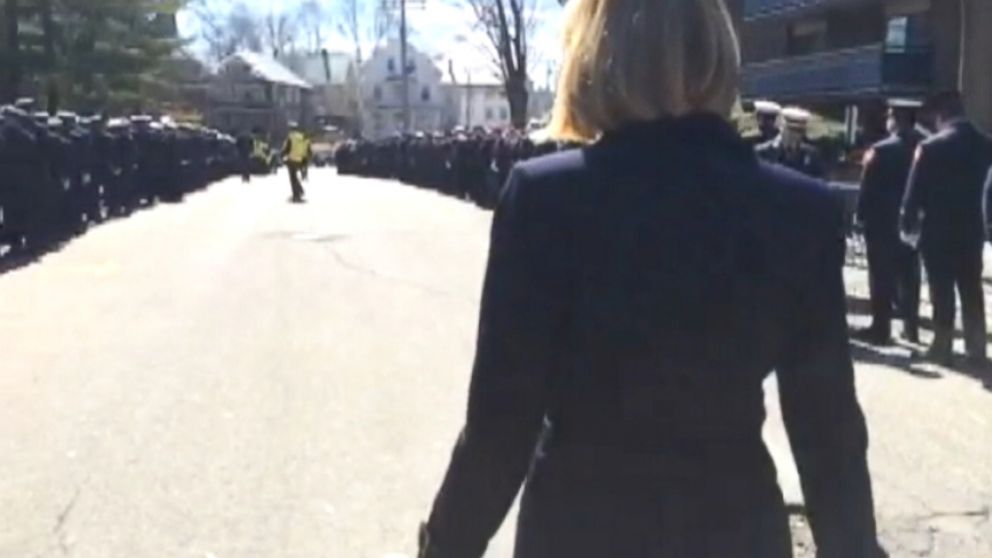 Hundreds of mourners pay tribute to two firefighters who died in an apartment fire.