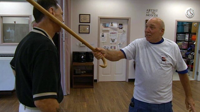 PHOTO: Edward Pacetti, 72, right, demonstrates his cane fu skills on Cane Masters instructor Merle McAlpin.