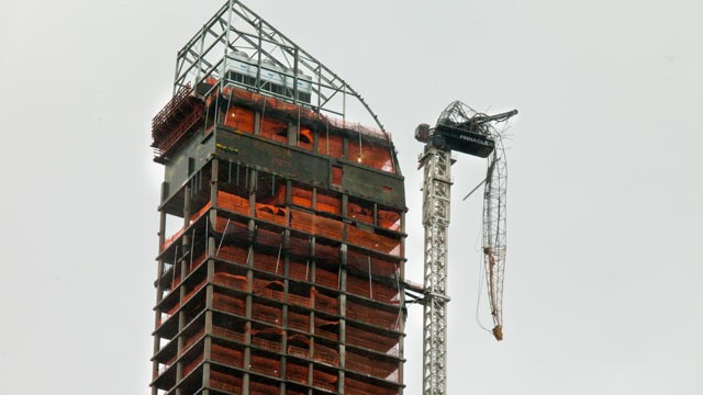 PHOTO: A construction crane dangles off of a skyscraper in midtown New York, Oct. 29, 2012.