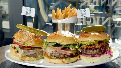 PHOTO: DBGB's restaurant offers a "menage à trois" Burger dish, including 3 different burgers, The Yankee, The French and the Piggy, New York City, July 25, 2012.