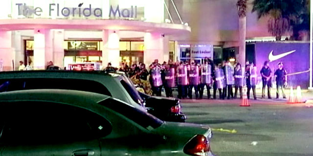 PHOTO: Law enforcement officers pulled out riot gear to control a mob of people who became unruly outside the Florida Mall after the release of a new pair of basketball shoes was canceled.