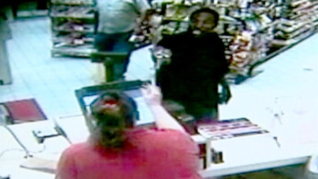 PHOTO: In this 2010 surveillance video, Ted Edmonds walked into a rural Virginia gas station during an armed heist, and hit the armed assailant with a beer bottle.
