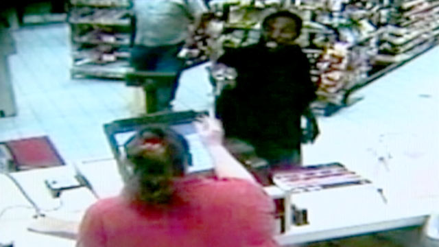 PHOTO: In this 2010 surveillance video, Ted Edmonds walked into a rural Virginia gas station during an armed heist, and hit the armed assailant with a beer bottle.