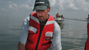 PHOTO Greenpeace marine biologist John Hocevar points on the map where damage has been done by the oil spill.