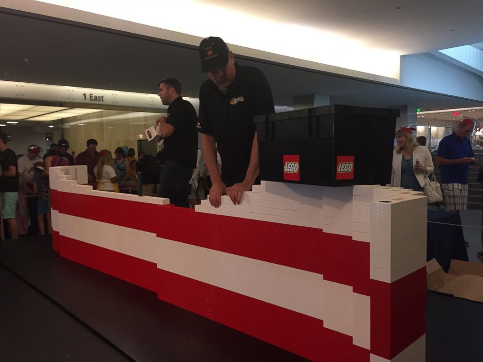 PHOTO: More than 15,000 museum visitors helped father-son LEGO master builder team Dan and Chris Steininger create the 9.5-by-14-foot flag.