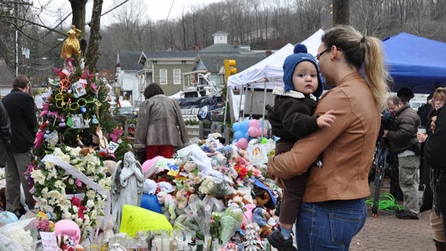 PHOTO: Ana Deaguiar, 21, and her 16-month-old son Giovanni visit the Sandy Hook Elementary School shooting memorial in Newtown, Conn., on Dec. 18, 2012.
