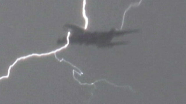 PHOTO: Lightening strikes a plane as it lands in London.