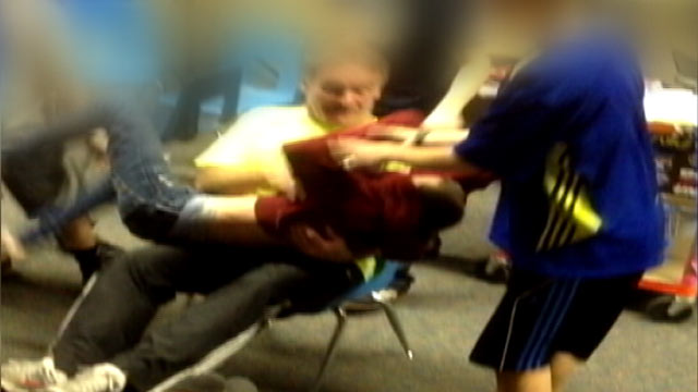 PHOTO: A video of Karla Kinneys 13-year-old son being dragged across the classroom by teacher and fellow student.