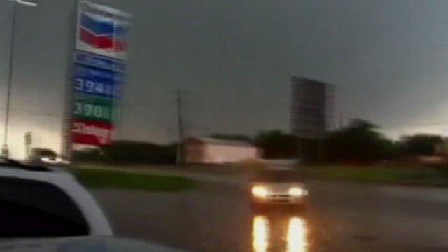 VIDEO: Drivers seeking shelter from powerful wind and rain pull into a gas station.