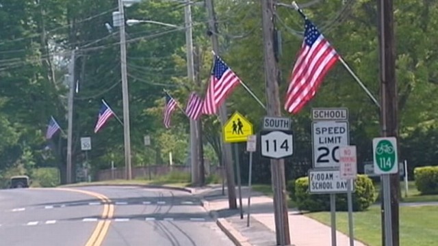 VIDEO: Community honoring fallen soldier is charged for hanging flags on utility poles.