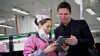 PHOTO: Nightline Co-Anchor Bill Weir shows Foxconn employee Zhou Xiaoying photos of his family on his iPad, which once upon a time was assembled in a Foxconn factory floor.