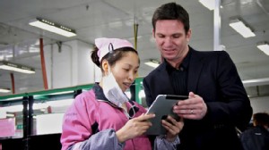 PHOTO: Nightline Co-Anchor Bill Weir shows Foxconn employee Zhou Xiaoying photos of his family on his iPad, which once upon a time was assembled in a Foxconn factory floor.
