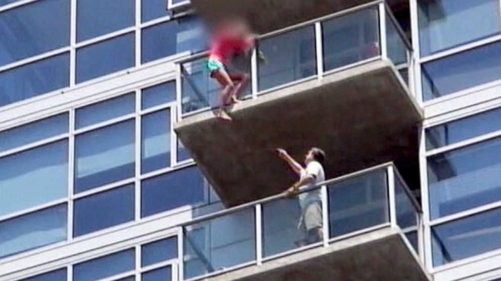 PHOTO: Stuntmen rushed into an apartment building to rescue a woman who was dangling from the balcony of the 14th floor.