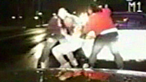 PHOTO A female passerby aided a police officer who was attacked by a driver.