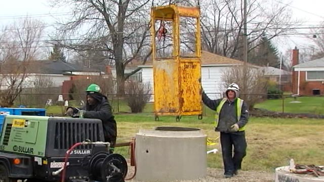 PHOTO: Sanitation workers at sewer