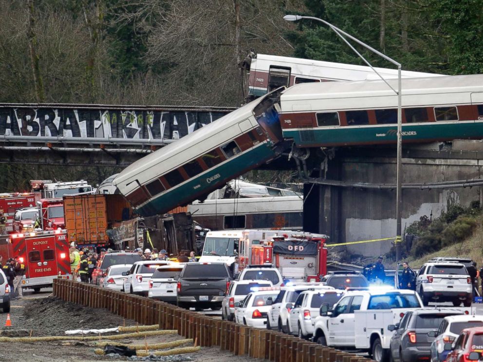PHOTO: Cars from an Amtrak train lay spilled onto Interstate 5 below as some remain on the tracks above, Dec. 18, 2017, in DuPont, Wash.