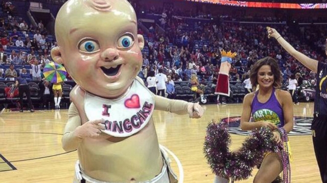 New Orleans Pelicans celebrate Mardi Gras with a giant replica of the tiny doll found in seasonal cake.