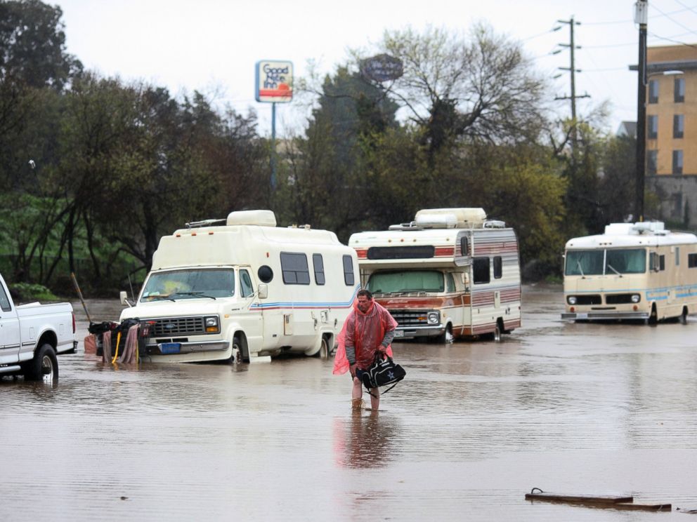 PHOTO: A man walks through a flooded street in Salinas, Calif. on Feb. 20, 2017.