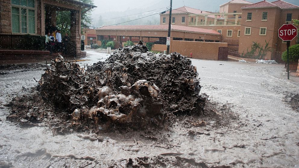 PHOTO: Flood water shoots out of a sewer on Canon Avenue on Thursday, Sept. 12, 2013, in Manitou Springs, Colo. 