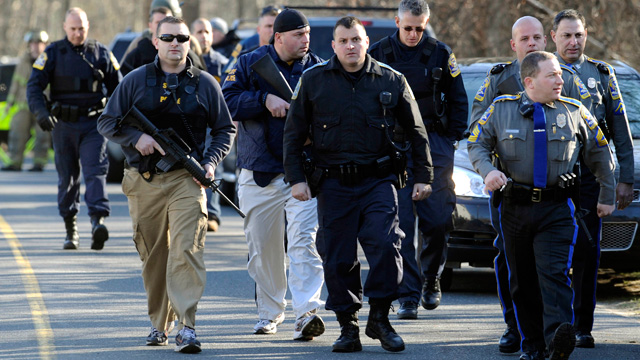 PHOTO: Law enforcement canvass the area following a shooting at the Sandy Hook Elementary School in Newtown, Conn., about 60 miles northeast of New York City on Dec. 14, 2012.