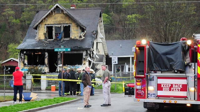 PHOTO: Firefighters and city officials look over the scene of a house fire on Saturday, March 24, 2012, in Charleston, in this photo provided by Jerry Waters.