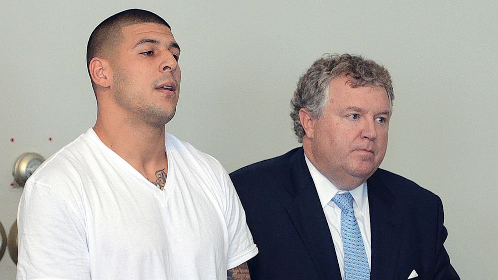 PHOTO: Former New England Patriots tight end Aaron Hernandez, left, stands with his attorney Michael Fee, right, during arraignment in Attleboro District Court on June 26, in Attleboro, Mass., where Hernandez was charged with murdering Odin Lloyd.