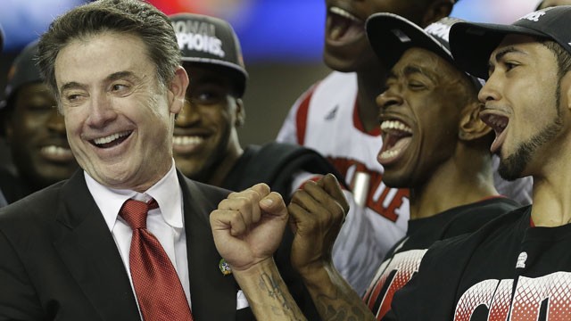 PHOTO: Louisville head coach Rick Pitino reacts with his team after Louisville defeated Michigan after the second half of the NCAA Final Four tournament college basketball championship game Monday, April 8, 2013, in Atlanta.