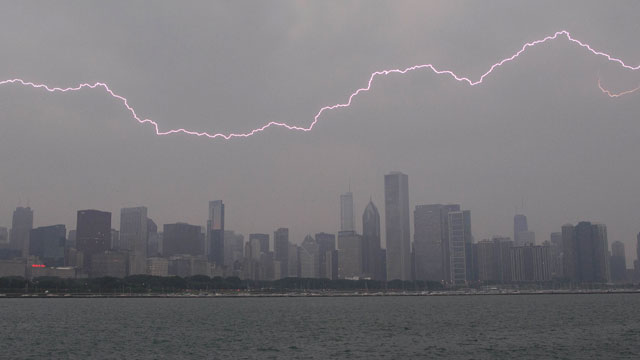 PHOTO: Lighting flashes over the Chicago skyline, Wednesday, June 12, 2013. An unusually massive line of storms packing hail, lightning and tree-toppling winds was rolling through the Midwest.