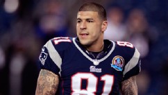 PHOTO: New England Patriots tight end Aaron Hernandez holds his helmet as he steps onto the field before an NFL football game between the New England Patriots and the Houston Texans in Foxborough, Mass., Dec. 10, 2012.