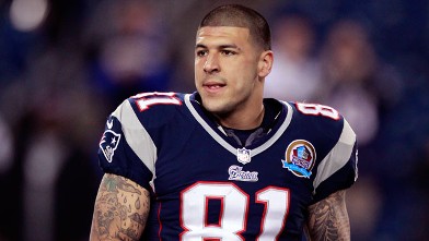 New England Patriots tight end Aaron Hernandez holds his helmet as he steps onto the field before an NFL football game between the New England Patriots and the Houston Texans in Foxborough, Mass., Dec. 10, 2012.