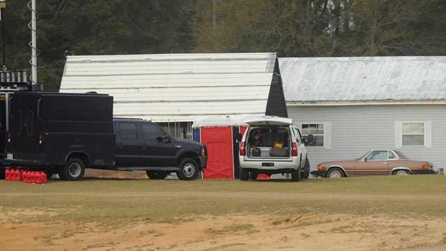 PHOTO: Law enforcement personnel station themselves on the property of Jimmy Lee Sykes, Feb. 4, 2013, in Midland City, Ala. Officials say they stormed a bunker in Alabama to rescue a 5-year-old child being held hostage there after Sykes, his abductor, was