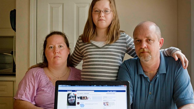 PHOTO: Alex Boston, 14, center, poses with her mom Amy, and father Chris and a screen shot of the phony Facebook account that was set up in Alex's name, April 26, 2012, at their home in Acworth, Ga.