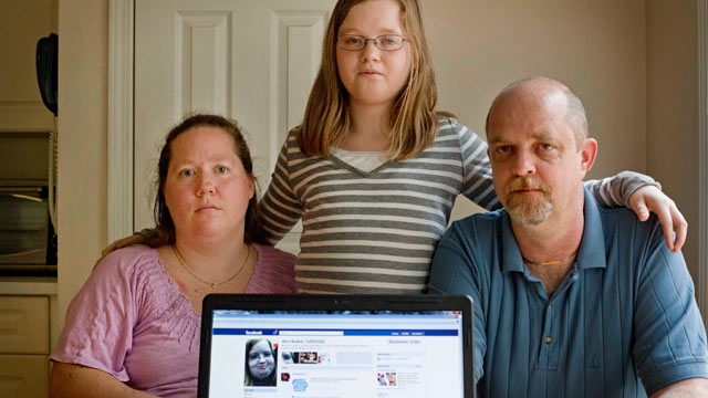 PHOTO: Alex Boston, 14, center, poses with her mom Amy, and father Chris and a screen shot of the phony Facebook account that was set up in Alexs name, April 26, 2012, at their home in Acworth, Ga.