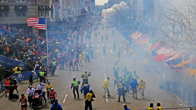 PHOTO: People react as an explosion goes off near the finish line of the 2013 Boston Marathon in Boston on April 15, 2013.